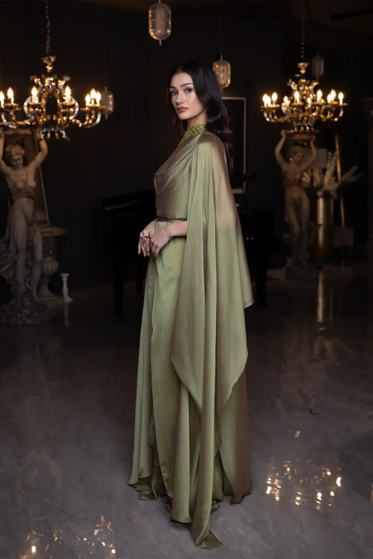 Side view of the Baroque Dress Chiffon by Vérité Majestique 2025, highlighting the graceful drape and structured silhouette in sage green.