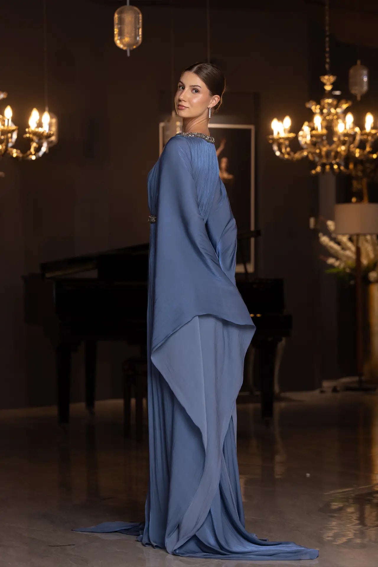 Side profile of Bloom Dress - Elegant Blue Chiffon | Pleated Skirt Style, highlighting the fluid drape and luxurious fabric texture.