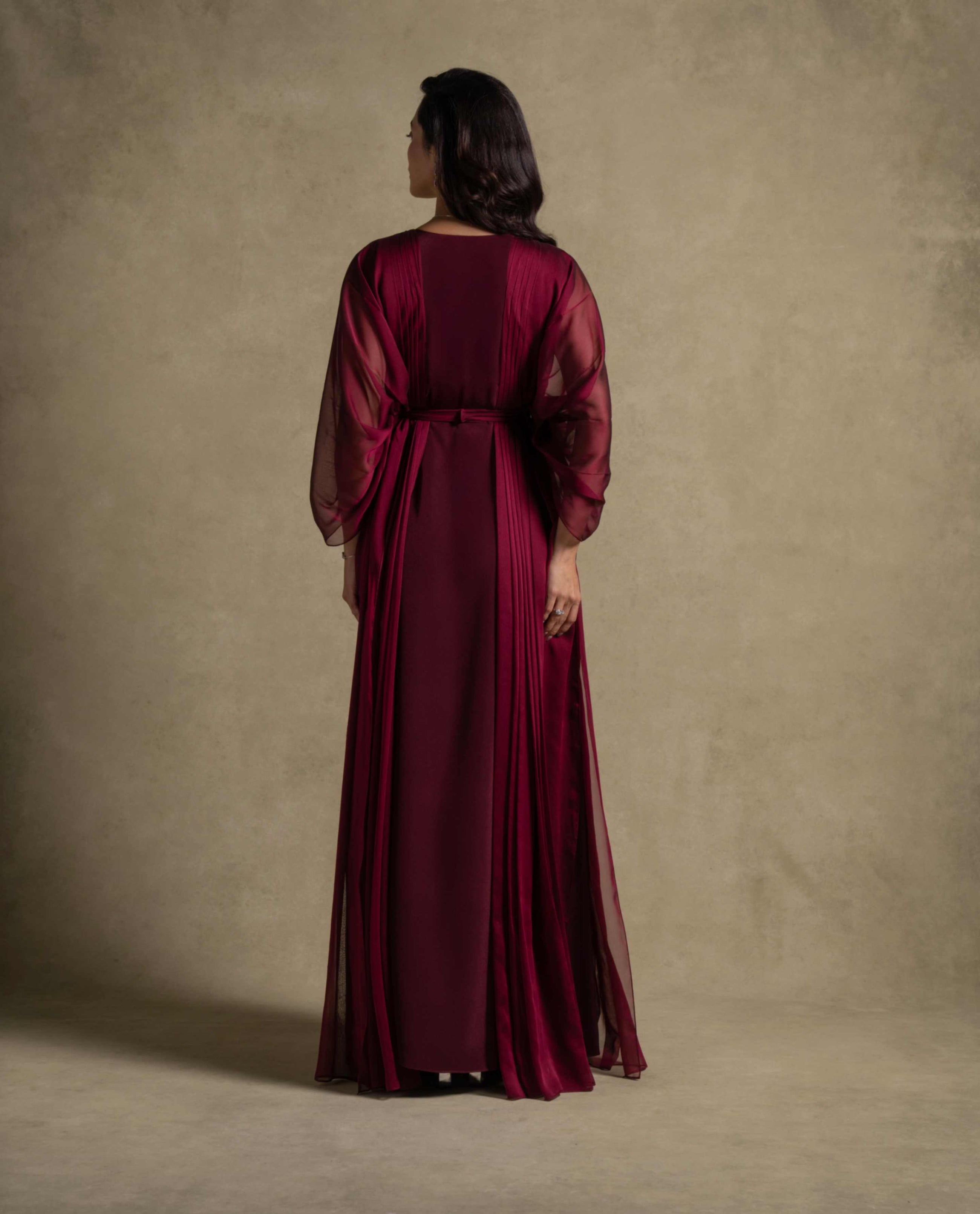 Burgaya Dress back view featuring a maroon chiffon gown with sheer sleeves, perfect for evening wear and luxury events.
