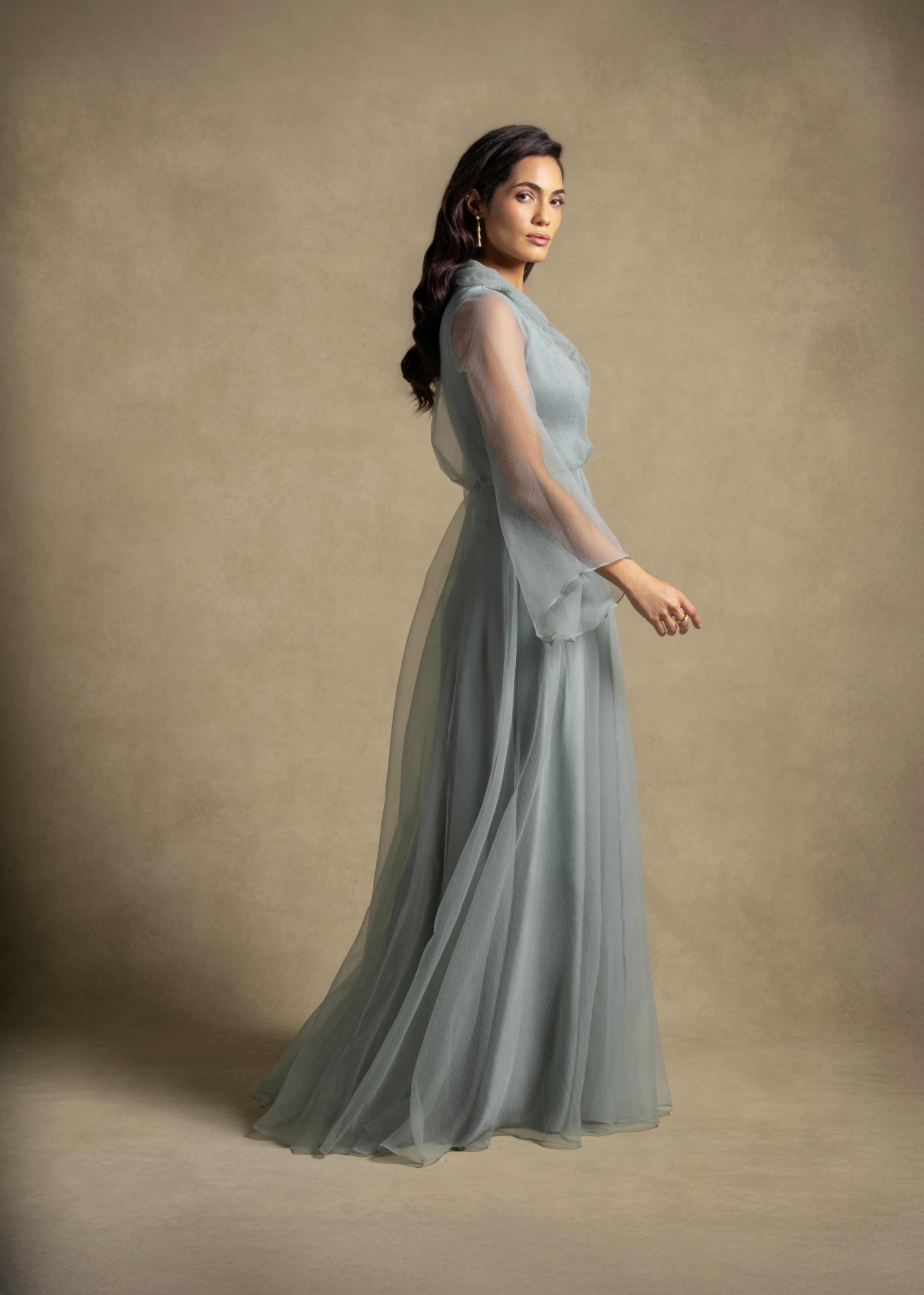 Gilded Dress in sage green, featuring flowing silhouette and sheer organza sleeves from the Zarina Collection.