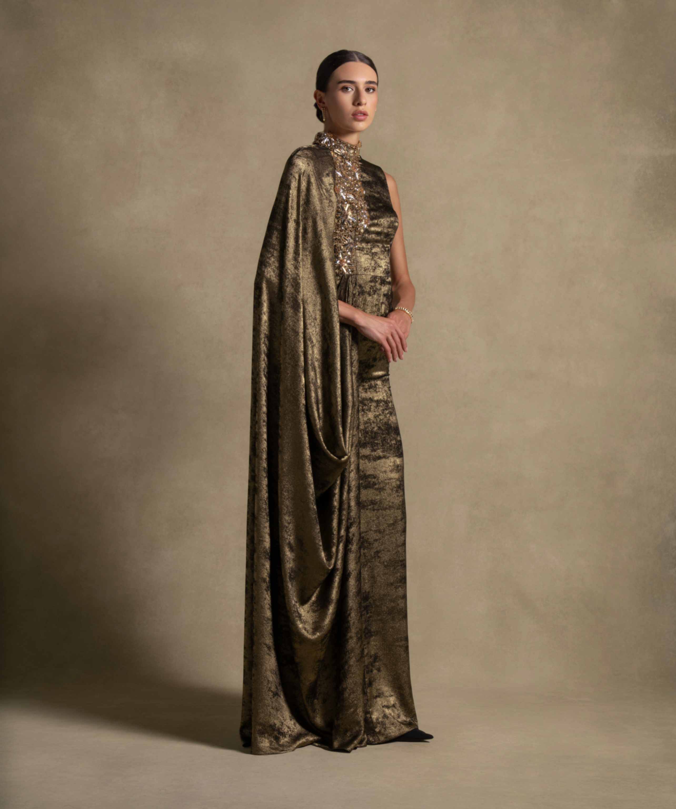 Grace Dress in fatigue green with draped cape overlay, high neckline and metallic accents, perfect for luxury evening wear.