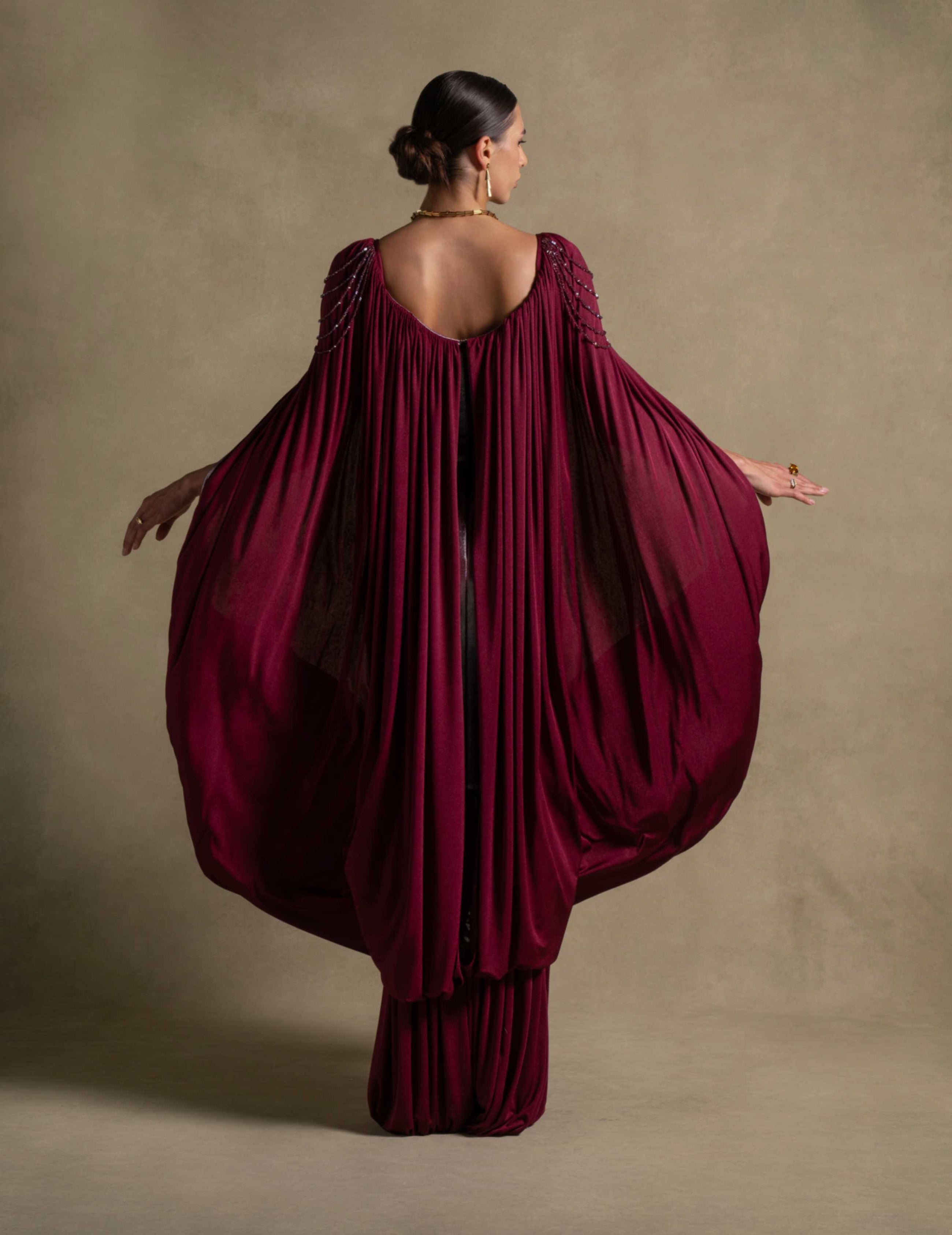 Vionna Dress in deep maroon showcasing sculpted bodice and draped jersey, perfect for luxury evening wear.