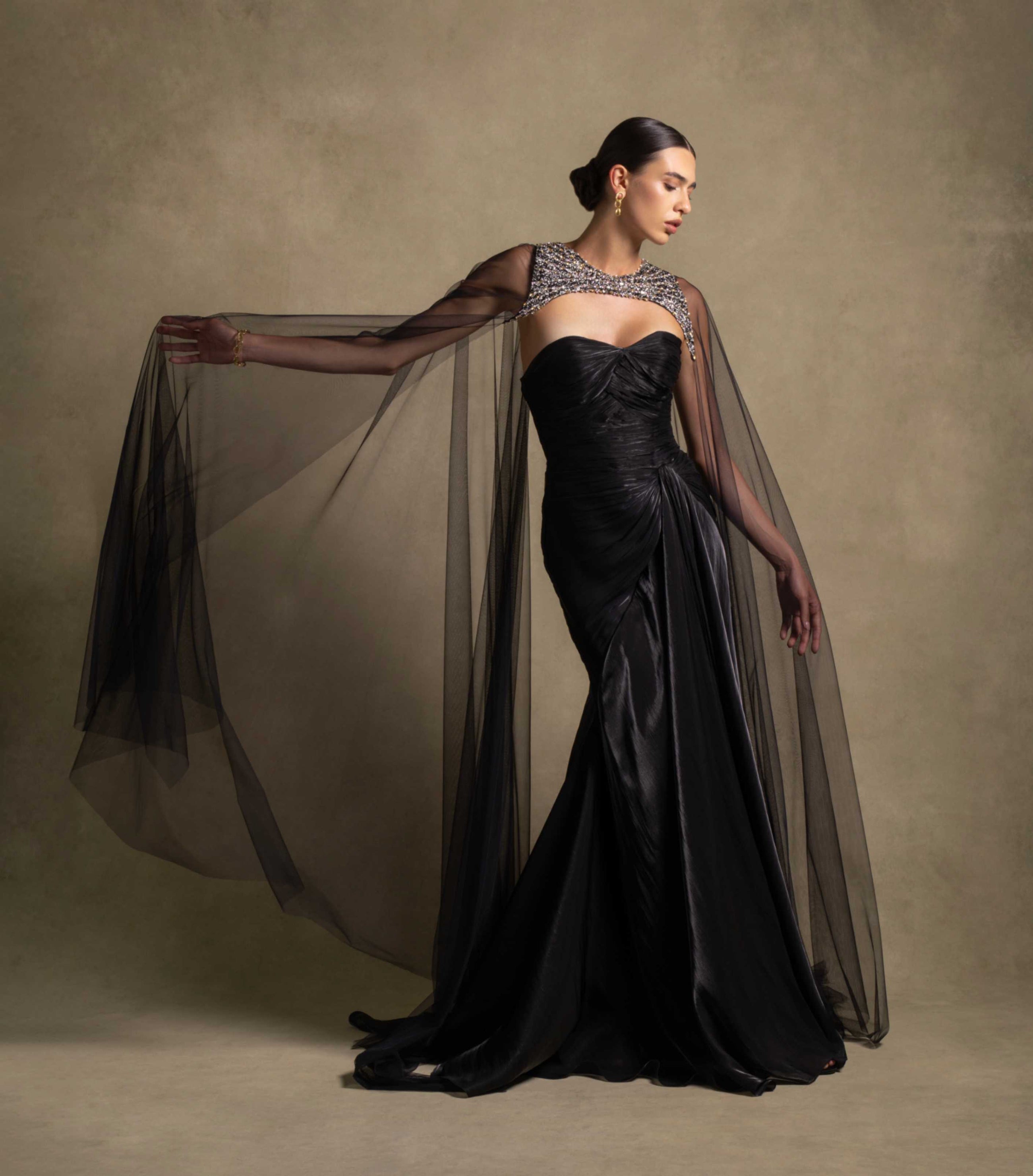Neriah Set couture black gown with sweetheart neckline and sheer tulle cape, showcasing luxury evening wear in high-end fashion.