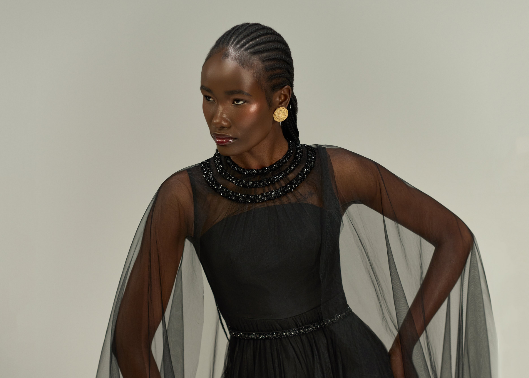 Elegant black jumpsuit with flowing cape for women, perfect for evening wear or red carpet events.