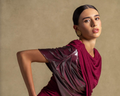 A model showcasing a luxurious burgundy dress as part of the luxury fashion new arrivals collection.