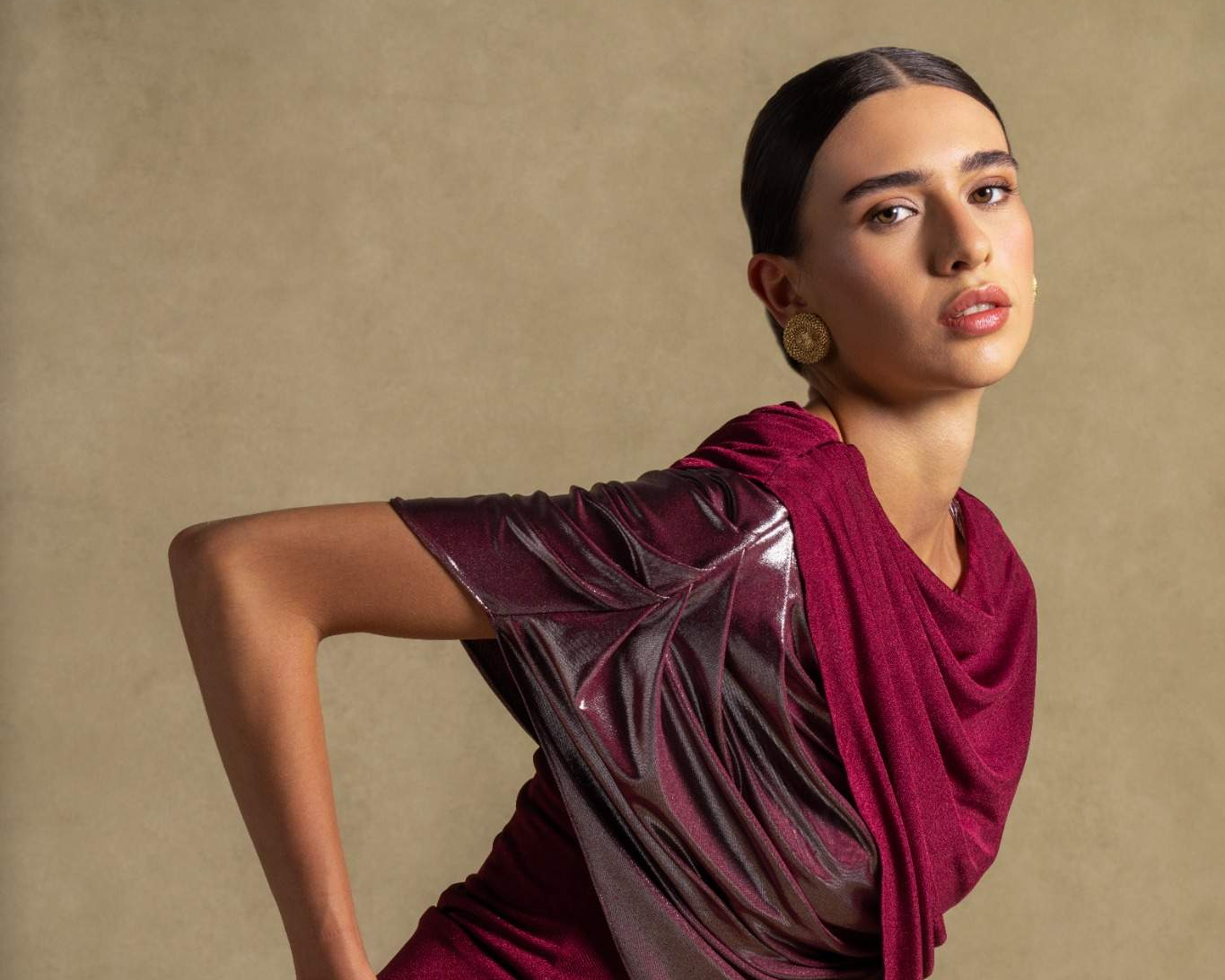 A model showcasing a luxurious burgundy dress as part of the luxury fashion new arrivals collection.