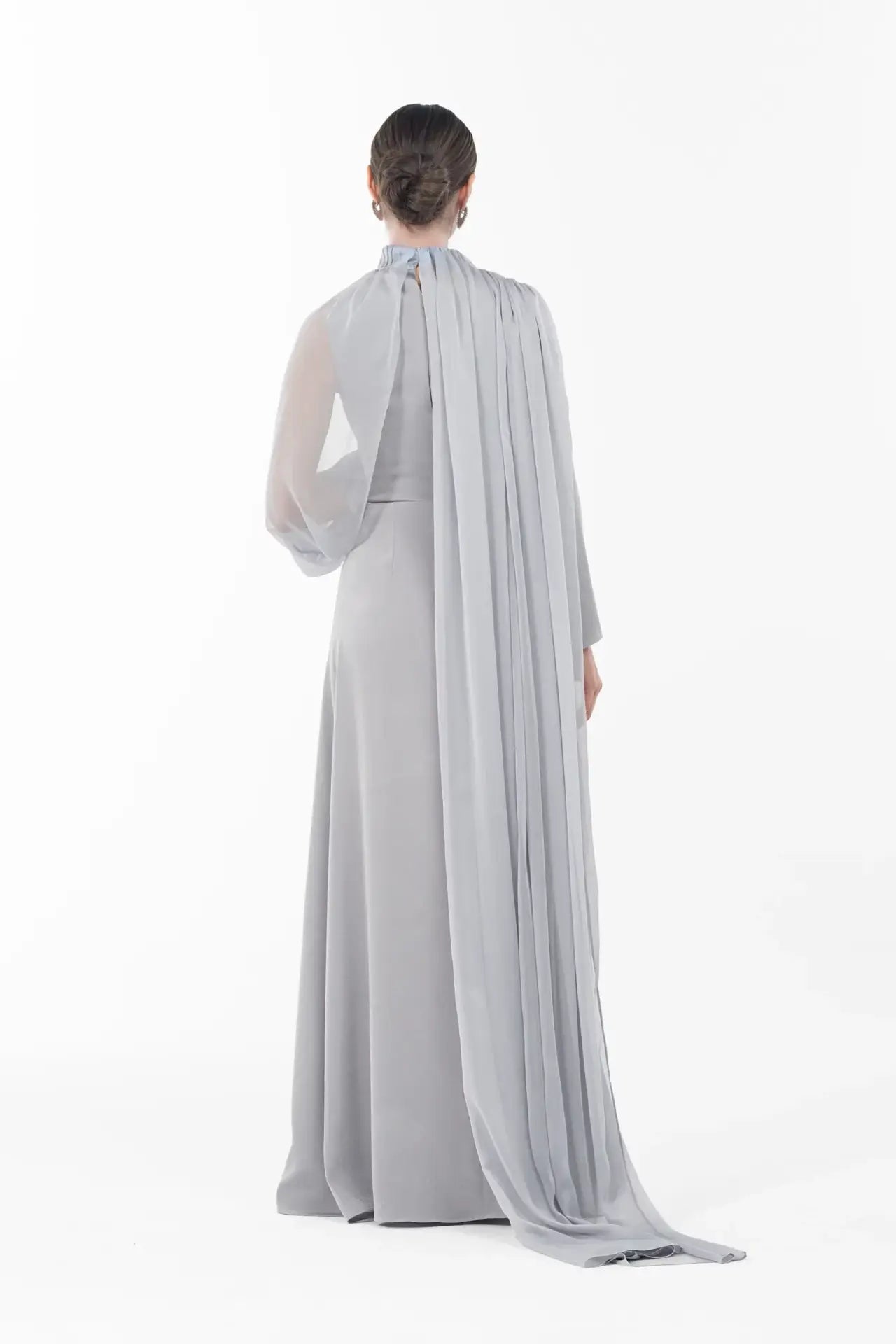 Back view of Rossettie Dress from Artista Eid - AW 2025 with long flowing chiffon cape and full-length satin gown, ideal for festive occasions.