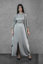 Front view of the Ella Dress from the Esperanza Collection AW24, featuring a satin finish, front slit, and elegant draped cape sleeves.