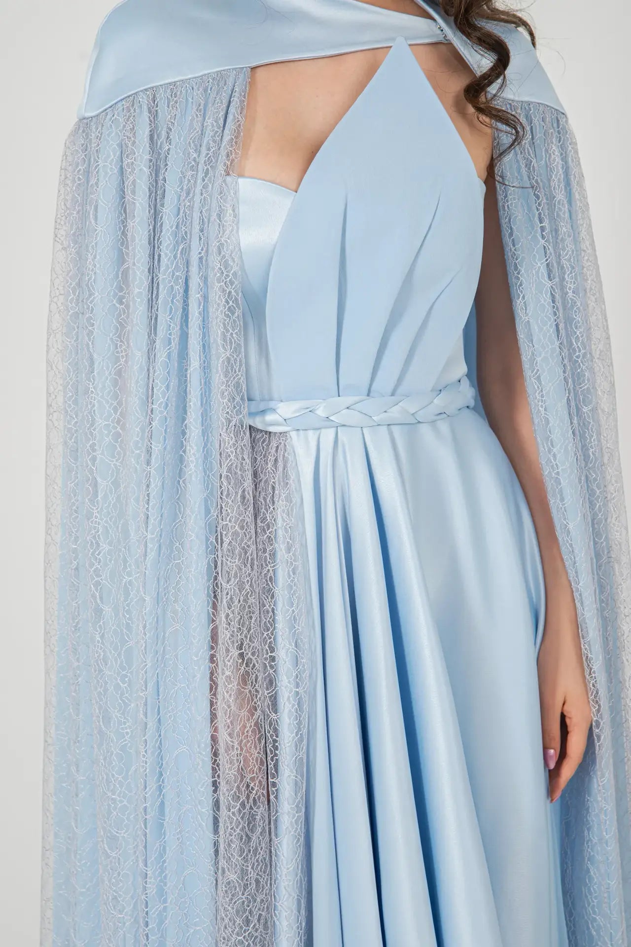 Close-up of Diamond Dress Baby Blue highlighting the pleated bust, braided waist detail, and sheer lace cape for a sophisticated finish.