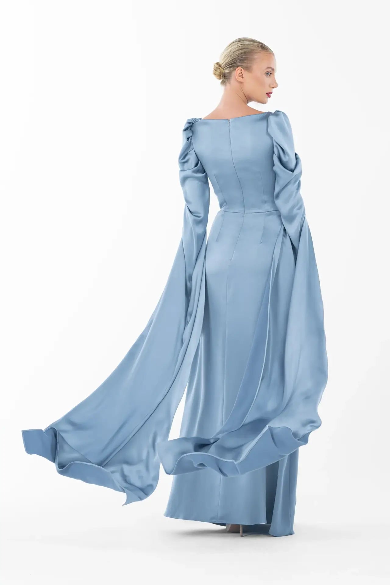 Back view of Cinderella Dress - Elegant Gown revealing long ruched sleeves and smooth satin finish, part of Artista Eid - AW 2025 collection.
