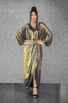 Full-length Hera Dress in metallic gold with overlap skirt, long sleeves, and side zip, part of the Esperanza Collection AW24.