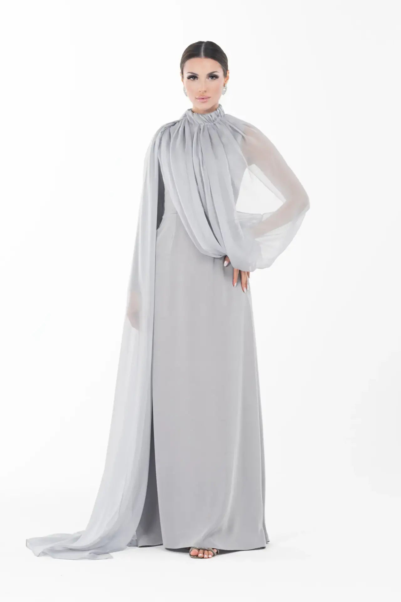 Elegant Rossettie Dress from Artista Eid - AW 2025 featuring a modest high neckline and sheer chiffon drape, perfect for formal Ramadan gatherings.