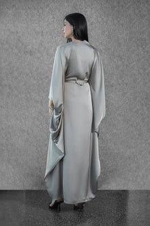 Back view of the Ella Dress - Satin Evening Gown with a defined waist and flowing cape-style sleeves, part of the Esperanza Collection AW24.