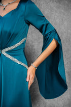 Detailed view of Solana Dress sleeve design with flared cuffs and rhinestone waist accents in teal satin.