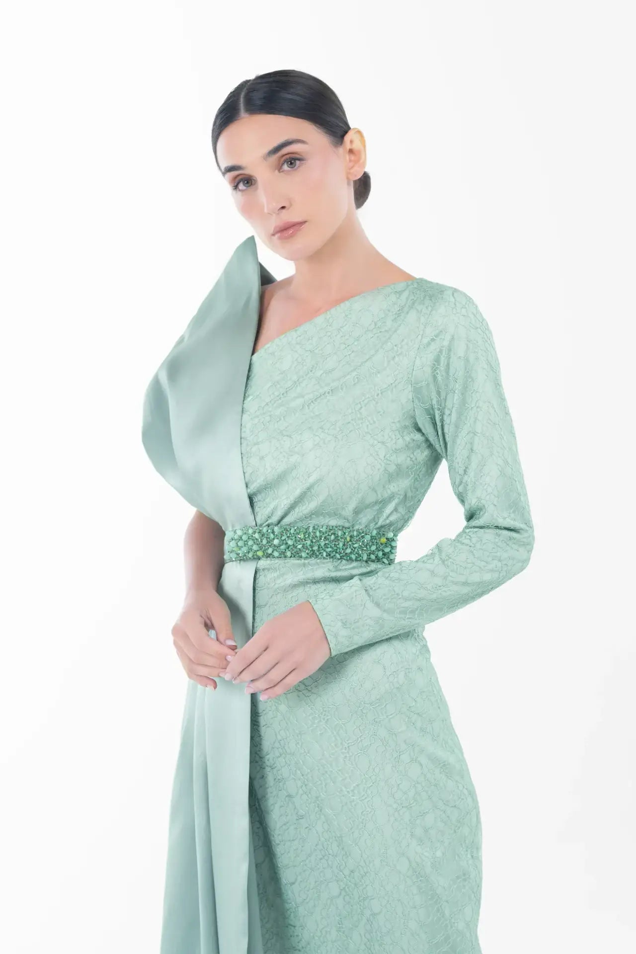 Close-up of Boticelli Dress Mint Green showing textured fabric, beaded waist belt, and elegant one-shoulder design from Artista Eid - AW 2025 collection.