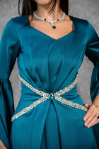 Close-up of Solana Dress waist detail showing rhinestone embellishments and teal satin fabric for elegant formal wear.