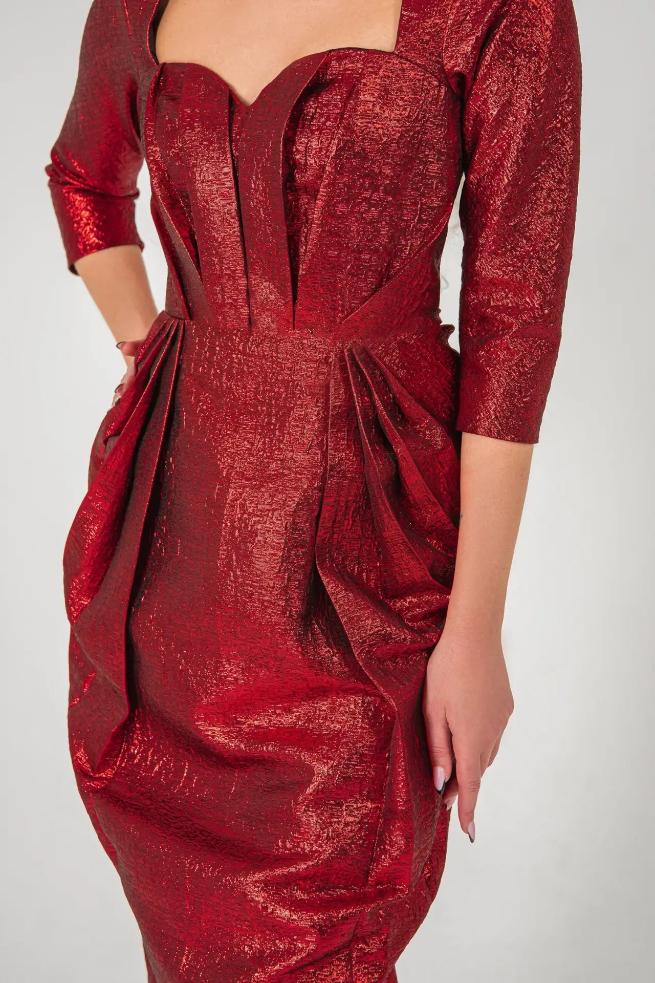 Close-up of Volcano Dress - Red Brocade Dress highlighting textured fabric, pleated bust, and tailored waist from STORM COLLECTION AW24.