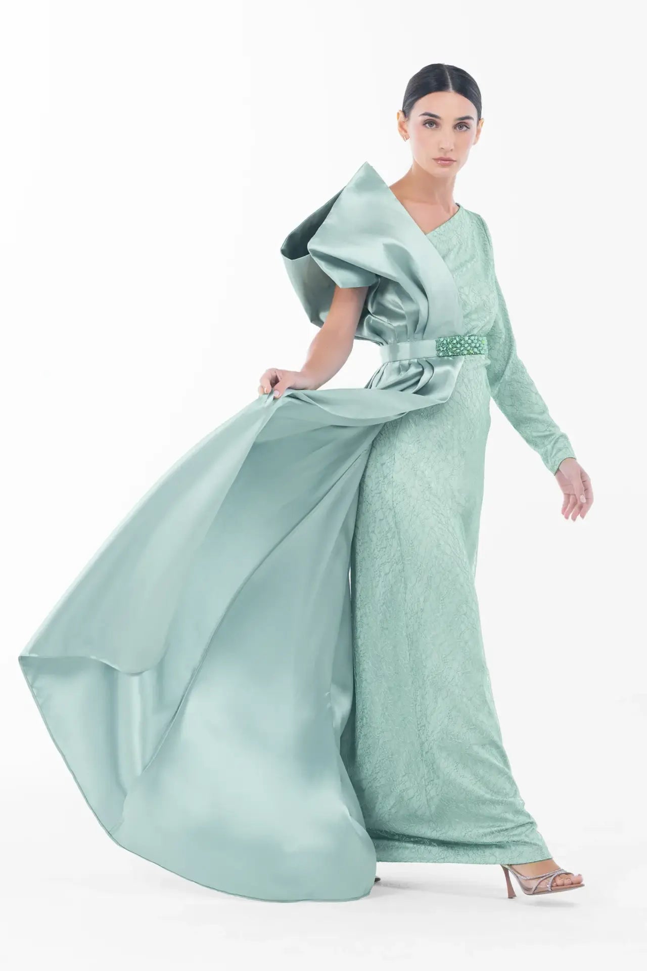 Model in motion wearing Boticelli Dress Mint Green with flowing satin overlay and sculptural bow, perfect for Ramadan 2025 evening events.