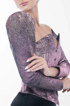 Close-up of Ralphael Dress sleeve showing textured amethyst metallic brocade fabric with sculpted shoulder detail, highlighting couture craftsmanship.