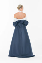Rear view of Ava Set Artista Ramadan 2025 with the coat draped low, revealing the bare back of the halter gown.