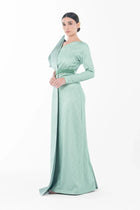 Side profile of Boticelli Dress Mint Green featuring long sleeves, fitted bodice, and elegant floor-length silhouette for Eid celebrations.
