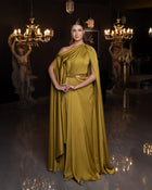 Ambre Dress - Olive Green One-Shoulder satin gown with embroidered belt, featuring elegant draping and cape sleeve. Ideal for formal events.