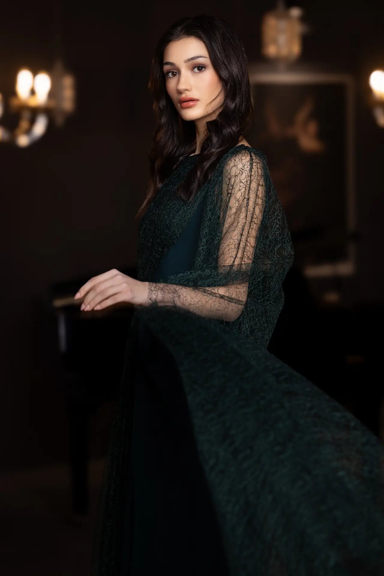 Close-up of Birkin Dress - Crepe Satin | Lace Bodice, Emerald Green highlighting intricate lace detailing and brooch accent on the shoulder.