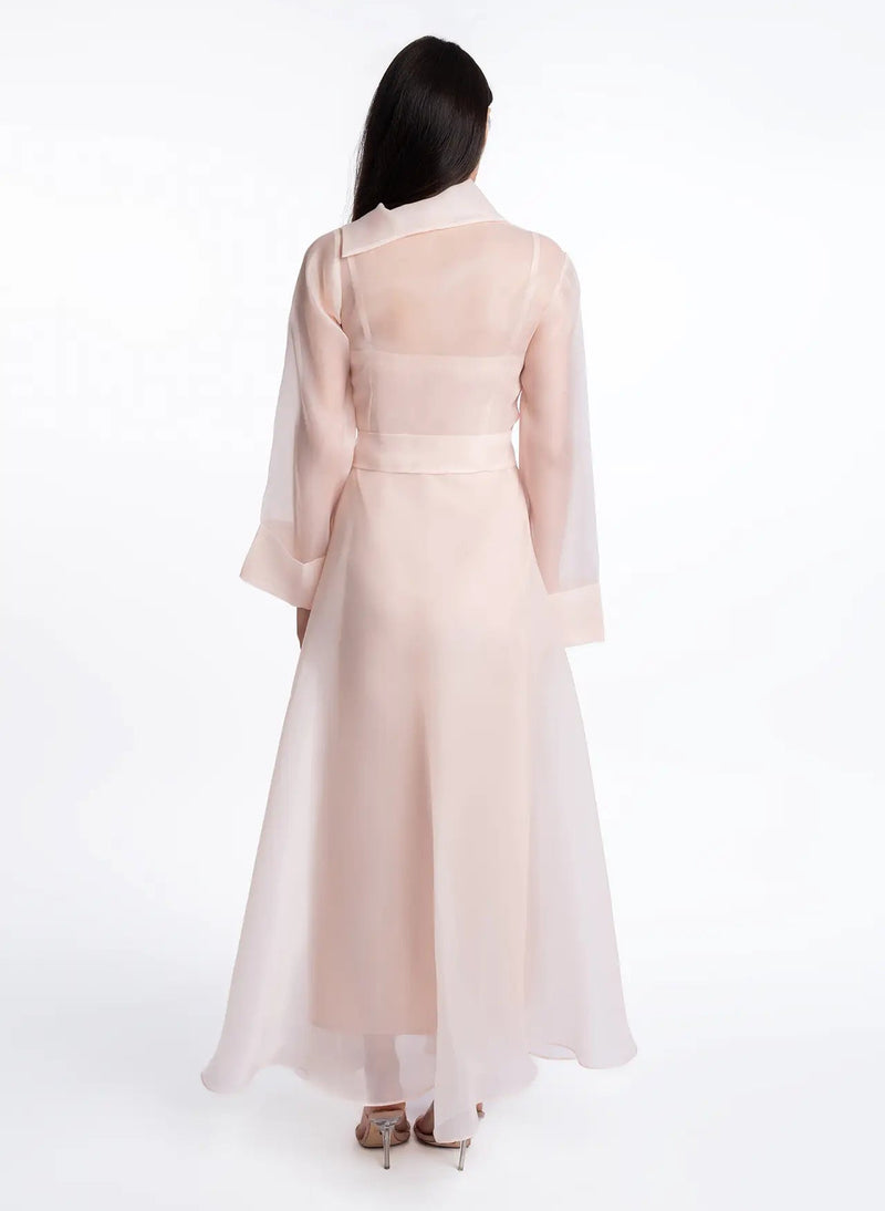 Back view of the Bella Dress in sheer organza, featuring a wrap-style top and flowing A-line silhouette.