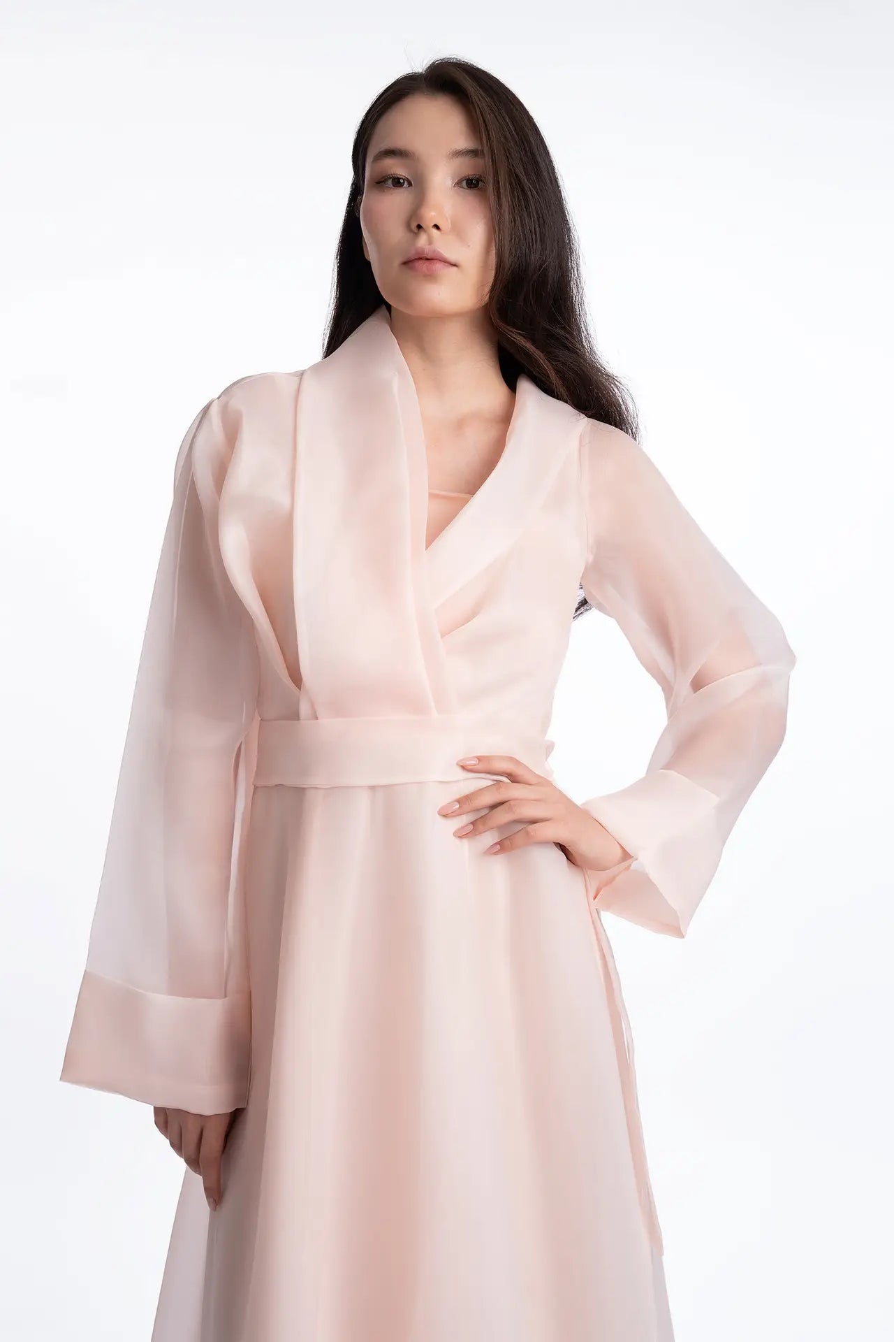 Close-up of the Bella Dress showing the wrap-style shawl collar and sheer organza texture, part of the Esperanza Collection AW24.