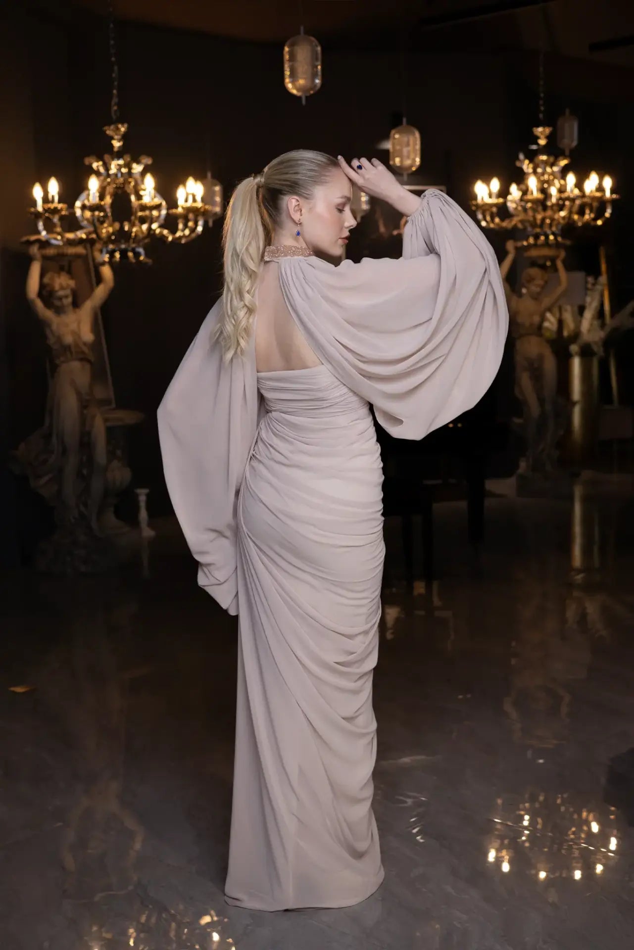 Side-back angle of Elora Dress - Beige Chiffon Elegance with ruched waist and flowing chiffon cape sleeves, ideal for formal occasions.