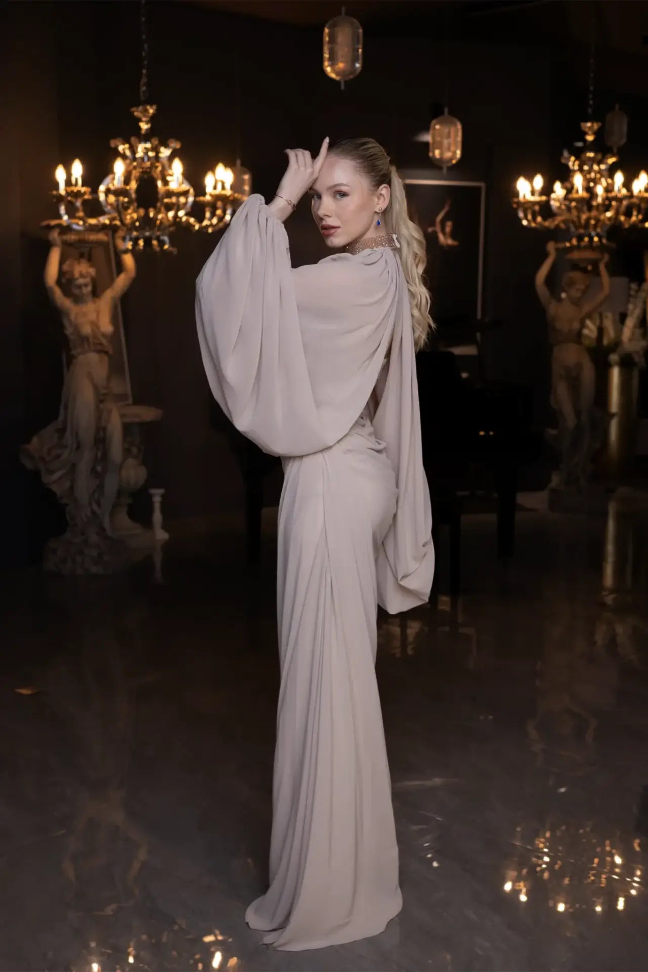 Back view of Elora Dress - Beige Chiffon Elegance showcasing the elegant drape and cape-style sleeves in a luxurious chiffon fabric.