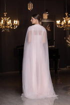 Back view of Lily Set - Blush Pink Taffeta Gown featuring flowing sheer cape overlay, ideal for elegant evening occasions.