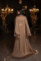 Back view of Kelly Set's sheer chiffon cape in golden brown, showcasing its flowing silhouette and formal appeal.