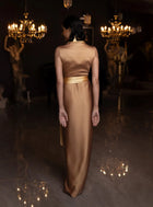Back view of Kelly Set gown in golden mustard satin, highlighting its sleek, tailored fit and formal design.