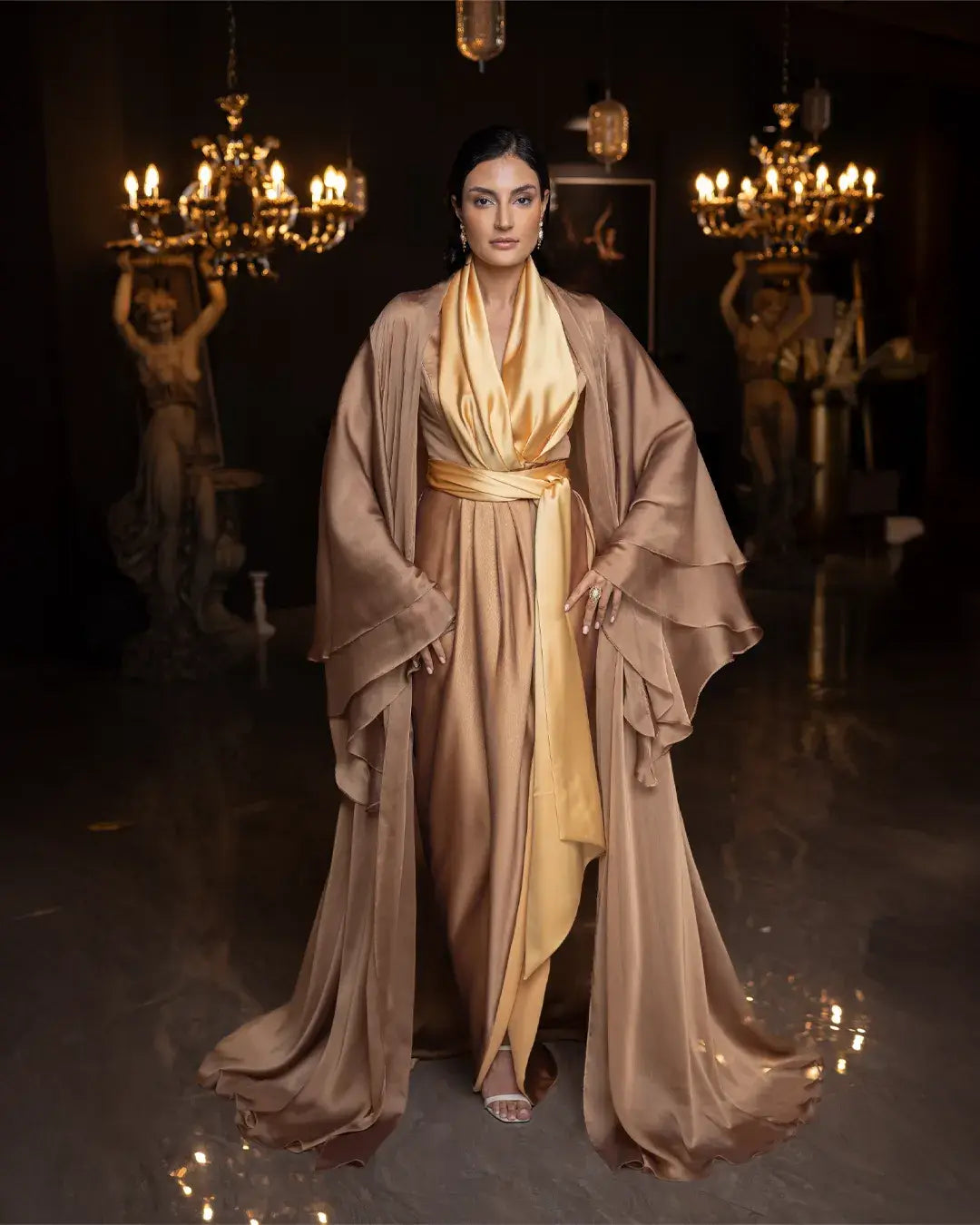 Kelly Set - Golden Mustard Elegance two-piece dress with flowing chiffon cape, styled for formal occasions in a luxurious setting.