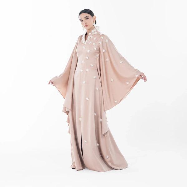 Allure Dress, a stunning blush beige high-neck maxi dress with floral embellishments and flowing sleeves, perfect evening wear.