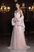 Elegant Miss Waad Dress from Verite Majestique PF2025 featuring spaghetti straps, embellished bodice, and voluminous cape in soft blush tones.