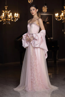 Elegant Miss Waad Dress from Verite Majestique PF2025 featuring spaghetti straps, embellished bodice, and voluminous cape in soft blush tones.