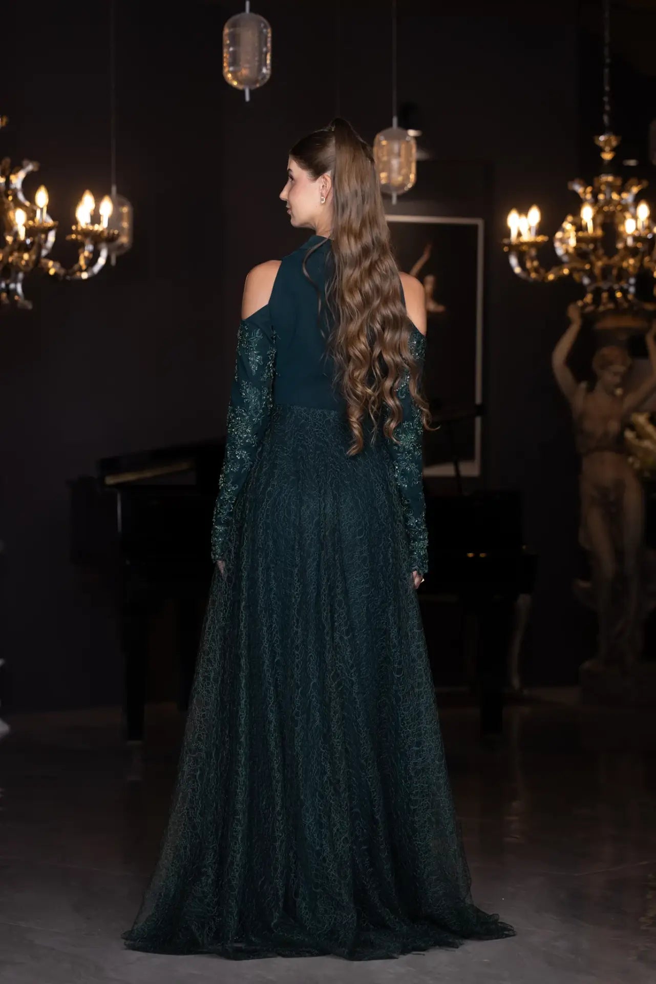 Rear view of the Pochette Dress - Emerald Green | Structured Silhouette with full-length lace skirt and open shoulders from PF2025 collection.