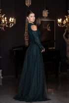 Back view of the Pochette Dress in Emerald Green with flowing lace skirt and shoulder cut-outs, part of Verite Majestique PF2025 collection.