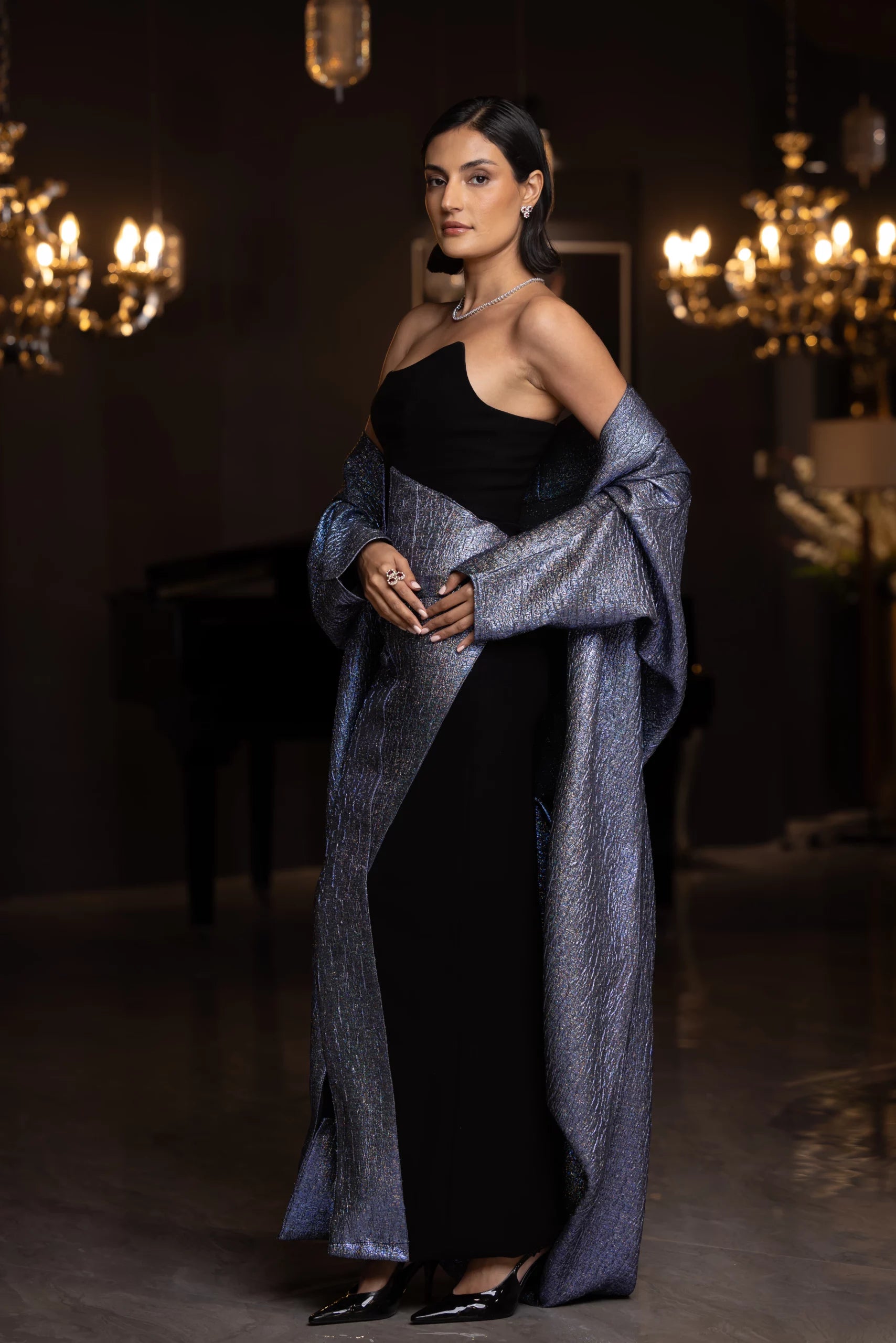 Elegant MissOvo Set from Vérité Majestique PF2025 collection, showcasing a black and metallic evening dress with asymmetrical neckline and luxe wrap.