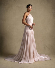 Avelisse Dress: Elegant beige couture gown with pleating, halter neckline, and flowing hem, ideal for evening wear and luxury fashion.
