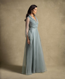 Gilded Dress in sage green with sheer organza sleeves, embodying luxury and elegance for high-end evening wear.