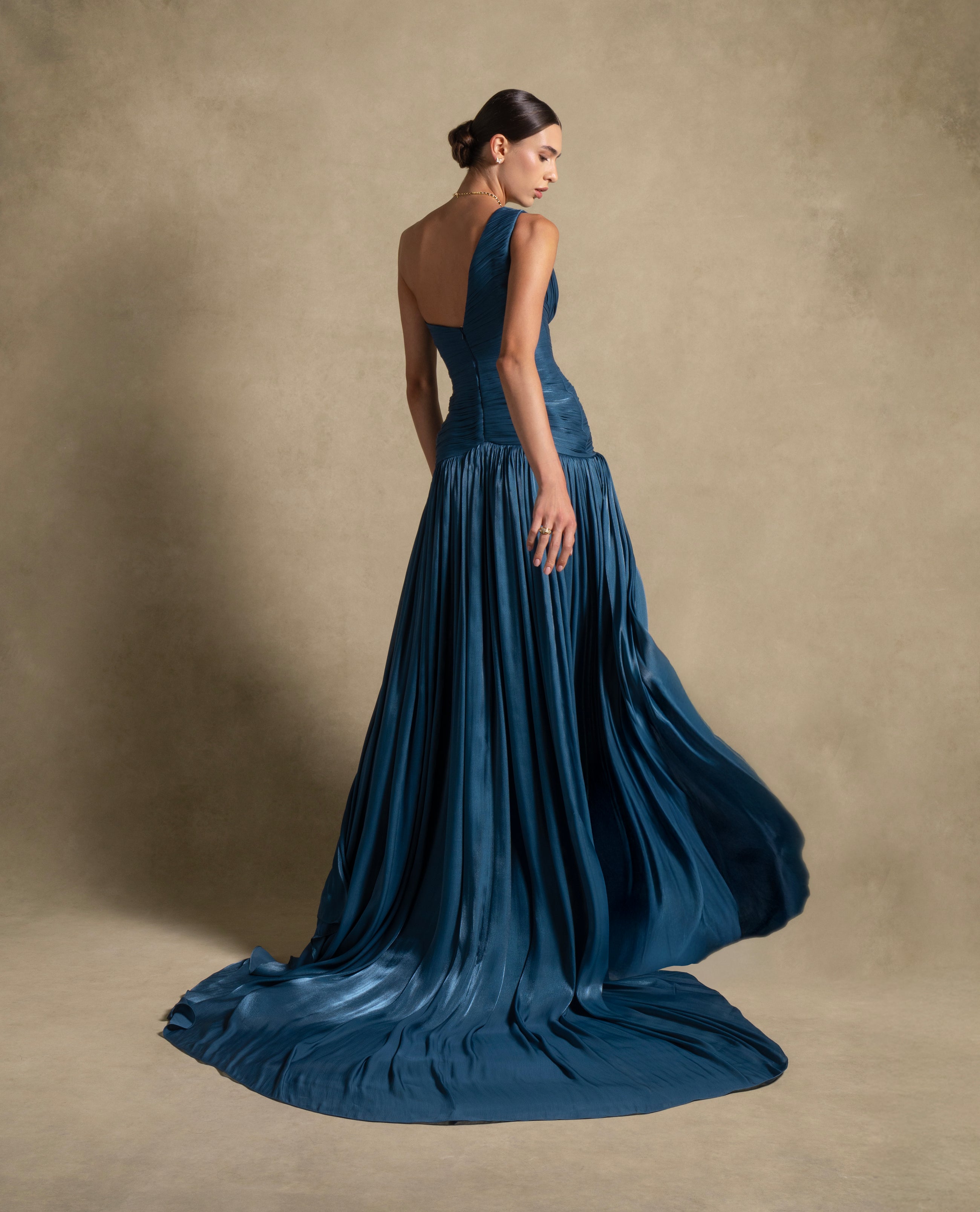 Layali Dress in turquoise, showcasing a one-shoulder design and flowing train, ideal for luxury evening wear.