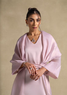 Isis Set worn by a model featuring luxurious pink quartz fabric and elegant shawl, representing high-end women's fashion.