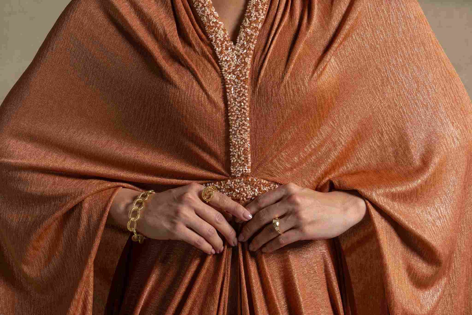 Moon Set from the Zarina Collection featuring a radiant Tangerine gown with a flowing silhouette and elegant detailing.