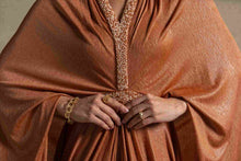 Moon Set from the Zarina Collection featuring a radiant Tangerine gown with a flowing silhouette and elegant detailing.