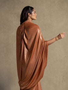 Moon Set gown in radiant tangerine showcasing flowing kaftan silhouette and shimmering foil finish for luxury evening wear.