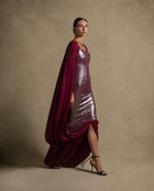 Vionna Dress in deep maroon with metallic bodice and draped panels, perfect for luxury evening wear and high-end fashion.