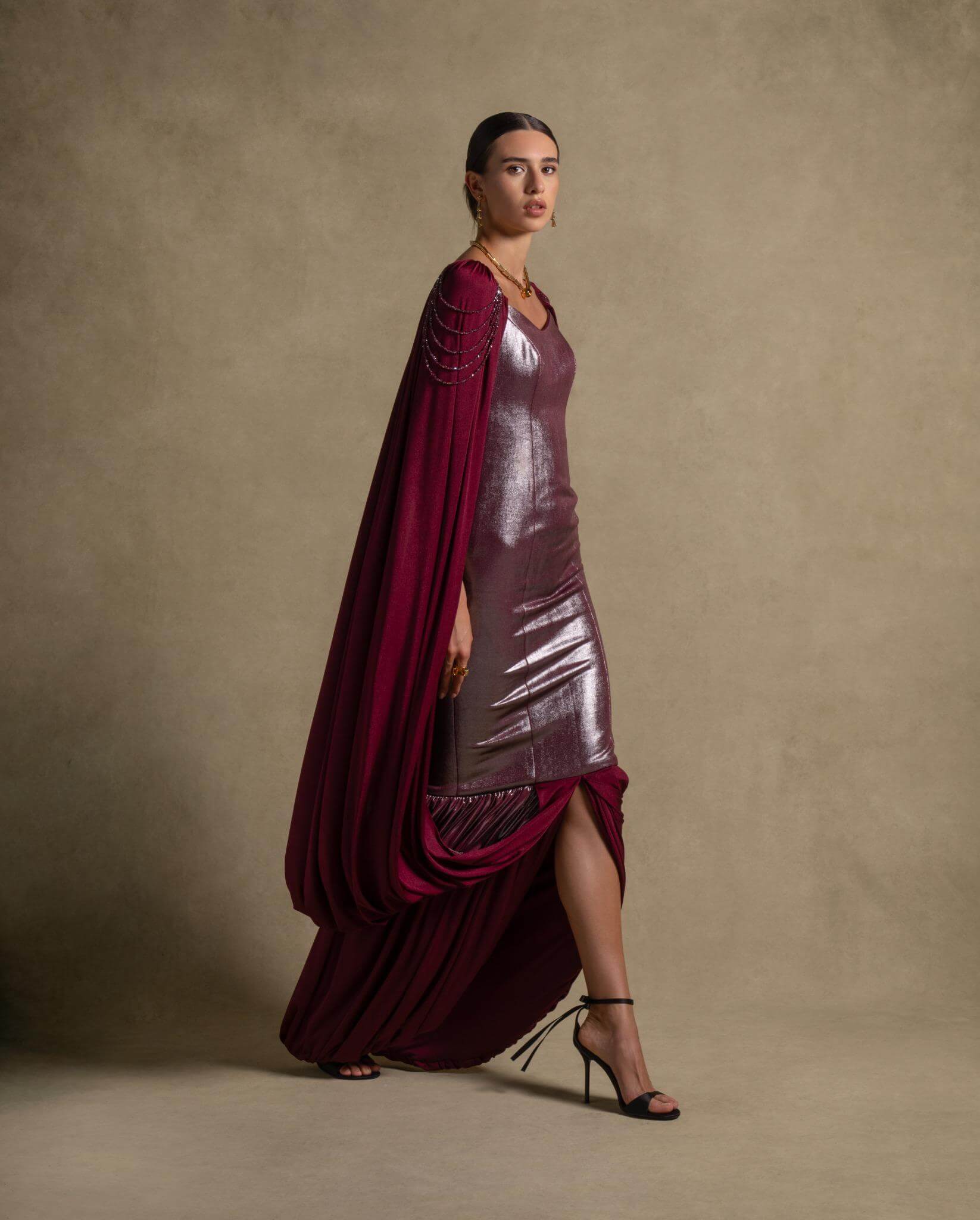 Vionna Dress in deep maroon with metallic bodice and draped panels, perfect for luxury evening wear and high-end fashion.